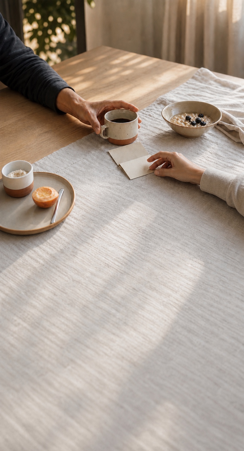 Two people sharing coffee and a small handwritten note at breakfast